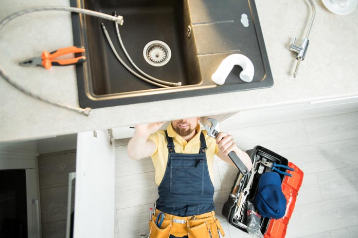 Foodservice Plumbing plumber repairing pipe kitchen