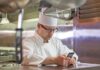 chef checking cell phone kitchen political speech Facebook