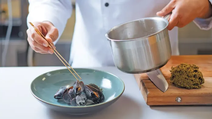 high food cost chef preparing exotic mussels dish