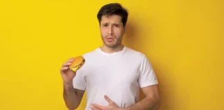 guy holding burger food-borne illness restaurant contamination insurance